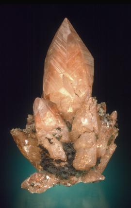 Calcite with native copper inclusions, Franklin Mine, Houghton County, Michigan. An iconic specimen, called “the rocket," is considered to be one of the finest copper included calcite specimens in the world. Specimen 8.5 cm tall. Photo by J. Scovil. (JTR 320)