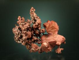 Copper, Phoenix Mine, Keweenaw Co., Michigan. An uncommon specimen with colorful cuprite and tenorite coatings. Specimen 6.3 cm tall. Photo by C. Stefano. (UM 1793)
