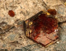 Shigaite, Bengal (Cannon) Mine, Iron County, Michigan. Micaceous brown-red shigaite crystal on matrix. Although rare, Michigan shigaites are among the best in the world. Field of view 3 cm wide. Photo by G. Robinson. (DM 27927)