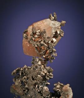 Calcite, silver and copper, South Hecla Mine, Houghton County, Michigan. Calcite, silver and copper, South Hecla Mine, Houghton County, Michigan. A unique specimen of copper-included calcite perched on silver crystals. Donor: W. Weir. Specimen 7 cm tall. Photo by G. Robinson. (DM 168)
